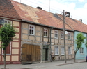 Zdjęcie przedstawia dom mieszkalny przy ul. Jana Pawła II 23 w Mieszkowicach. Na pierwszym planie widać frontową, ryglową elewację budynku.                                                             