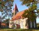 Zdjęcie przedstawia kościół od strony bocznej, zbudowany z czerwonej cegły.                                                                                                                             