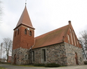 Zdjęcie przedstawia kościół od strony wejścia, który jest usytuowany na lekkim wzniesieniu.                                                                                                             