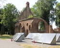 Zdjęcie przedstawia kaplicę św. Gertrudy w Chojnie. Na pierwszym planie widać pamiątkowe tablice, za nimi ruiny kaplicy.                                                                                